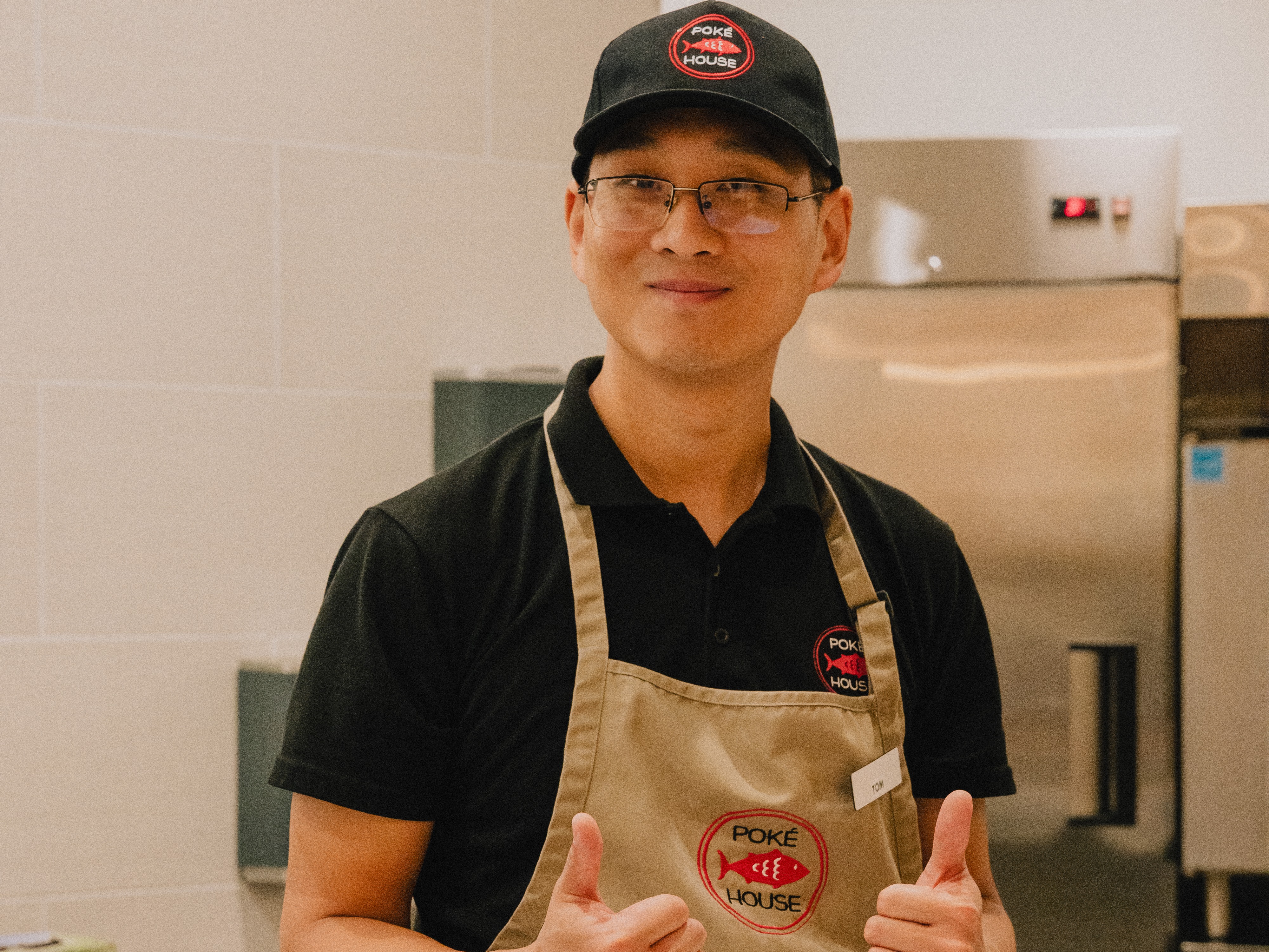 A Poke House franchisee smiling for the camera